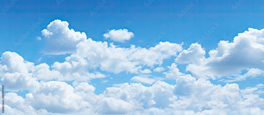 Poster Clouds arranged in picture perfect alignment against a clear blue sky creating an ideal backdrop for a copy space image