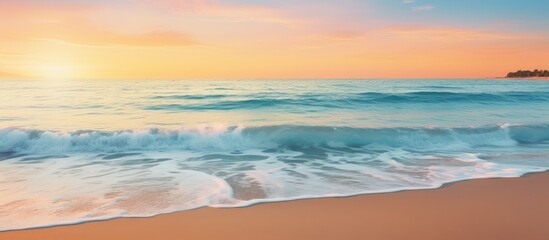 Obraz premium Tropical beach at sunset with blurry horizon for a summer themed copy space image featuring light sand and sparkling ocean water creating a natural seascape
