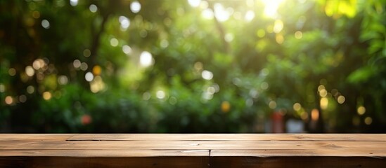 Wooden table featuring garden bokeh perfect for catering or food themes with a rural outdoor setting ideal for product displays with copy space image