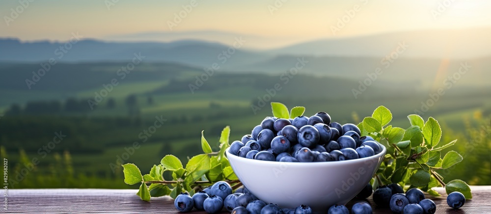 Aufkleber blueberries in a cup on the table with a scenic background ideal for copy space image