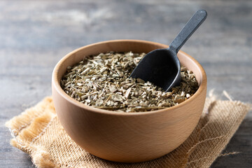 Traditional yerba mate in bowl on wooden table