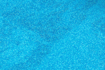 High angle view of clean swimming pool water with blue ceramic tiles at the bottom