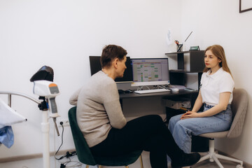 Fototapeta premium Young woman patient with a senior gynecologist during the consultation in the gynecological office