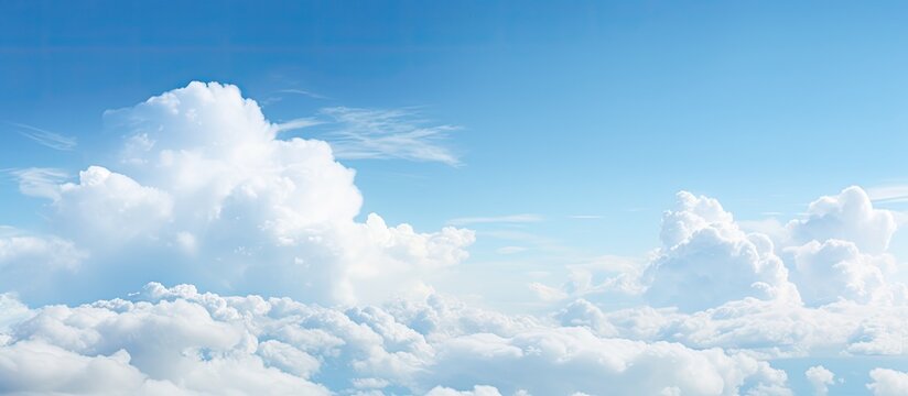 Sky filled with fluffy white clouds against a serene backdrop enhancing the beauty of the blue expanse and offering copy space image