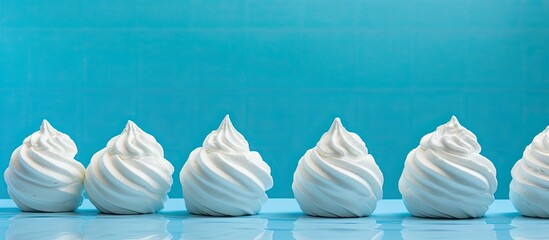 Ice cream shaped bath bombs on a blue backdrop with copy space image