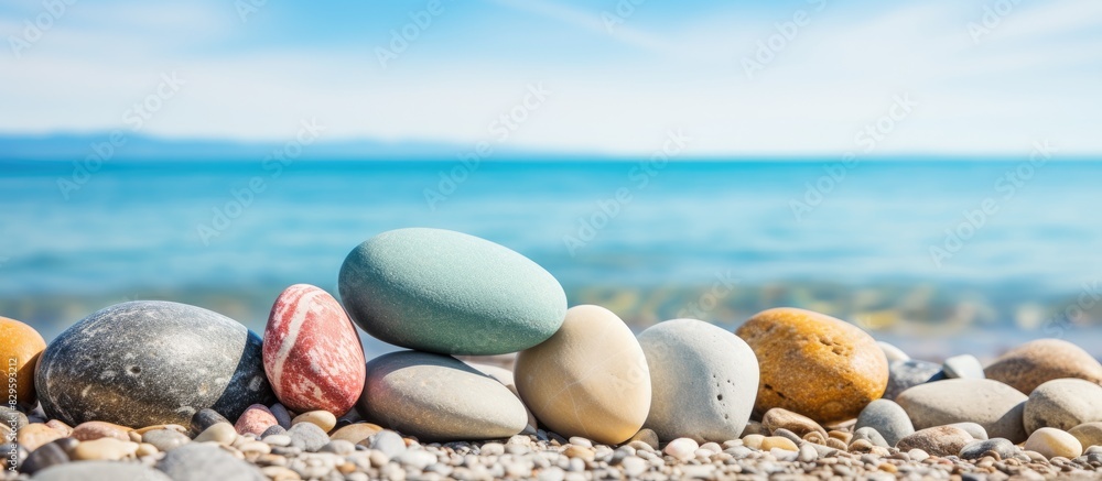 Poster smooth stones resting on the serene ocean shore with a beautiful copy space image available