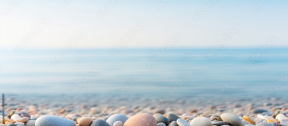 Poster smooth pebbles representing zen philosophy by the seashore with a tranquil copy space image