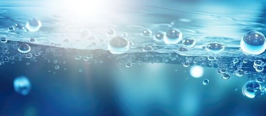A trendy abstract nature background featuring defocused transparent blue water with splashes bubbles and waves glistening in sunlight perfect for a copy space image