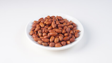 raw peanuts on a white background with studio lighting