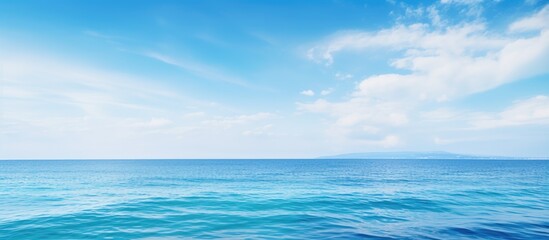 The serene blue sea and sky stretch endlessly creating a calming scene with a vast copy space image - Powered by Adobe