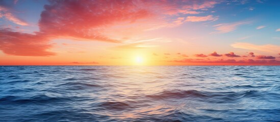 Obraz premium Scenic sunrise over the tranquil ocean with sun reflection capturing a serene moment in a copy space image