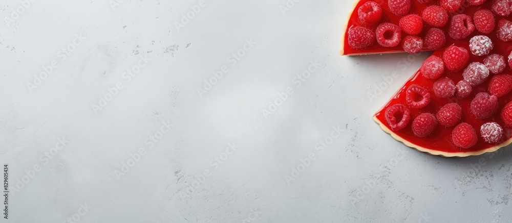Poster slice of tart with fresh and jellied raspberries on a light concrete background in a top down view w