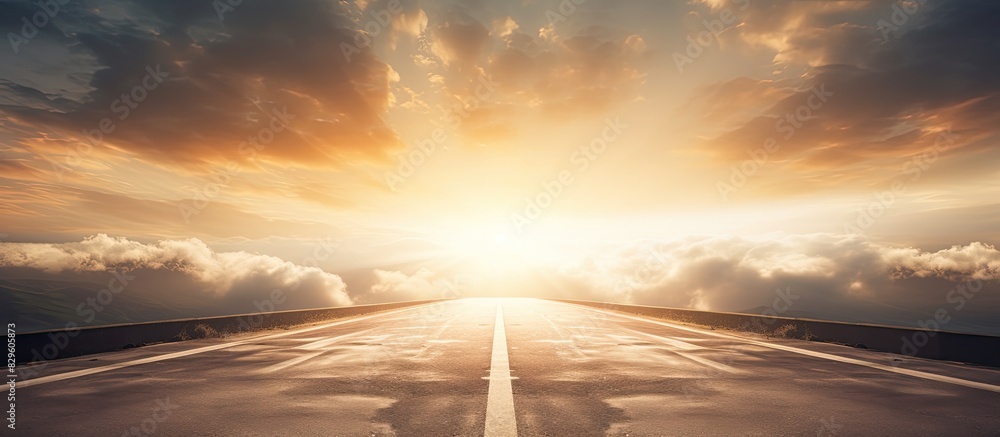 Poster an empty road with the sun breaking through clouds above perfect for a copy space image