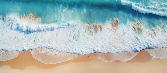 Aerial view of tropical beach surf with crashing waves showcasing an abstract ocean scene with copy space image