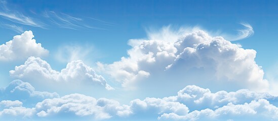 A serene blue sky with fluffy white clouds is an ideal choice for a background image on a website or in artwork due to its calming and peaceful nature. Copy space image