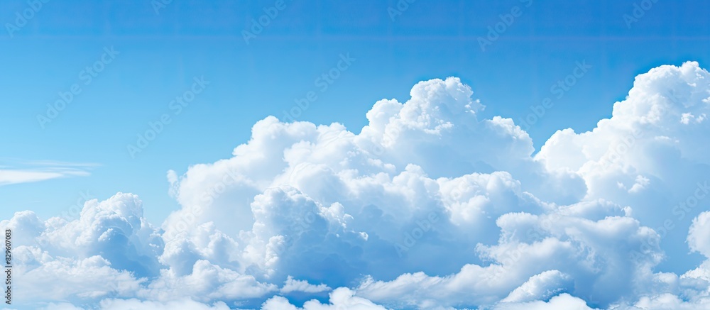Poster fluffy white clouds complementing the blue sky with a copy space image