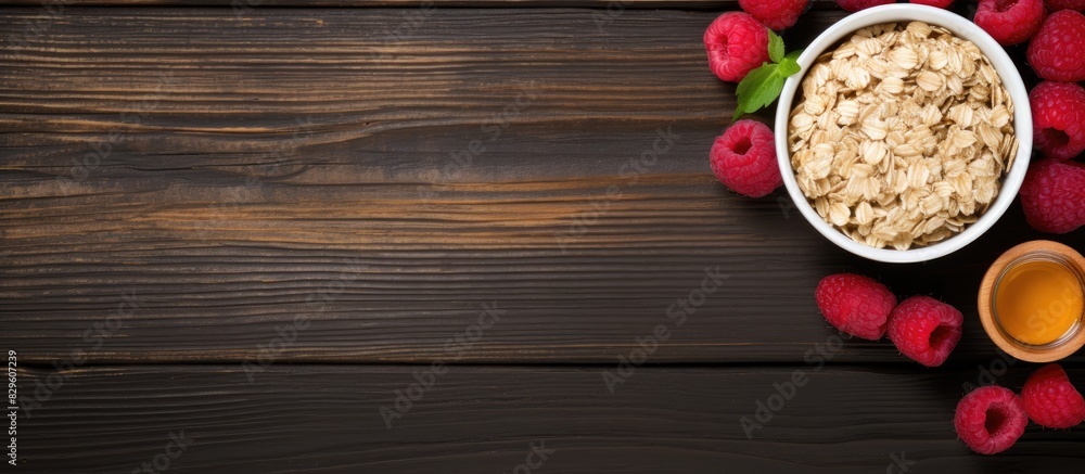 Poster top view horizontal image of oatmeal with raspberries and honey with copy space image