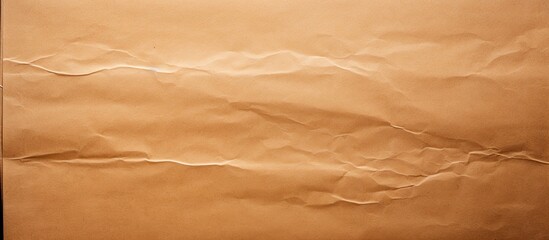 Fototapeta premium Brown cardboard texture with a transparent adhesive tape strip and some wrinkles Carton structure of a packaging box used for shipping and delivery. Copy space image. Place for adding text and design