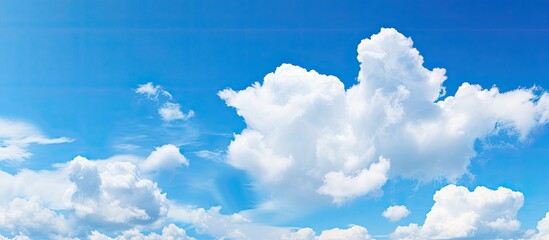 Beautiful sky background featuring a blue sky with white clouds ideal for a copy space image