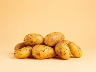 heap of potatoes on beige background