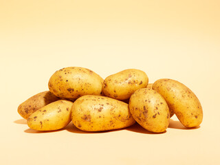 heap of potatoes on beige background