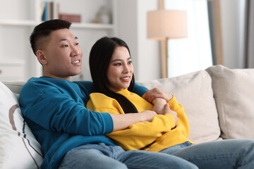 Happy young couple on sofa at home