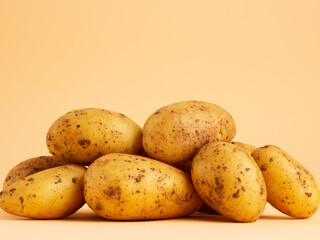 heap of potatoes on beige background