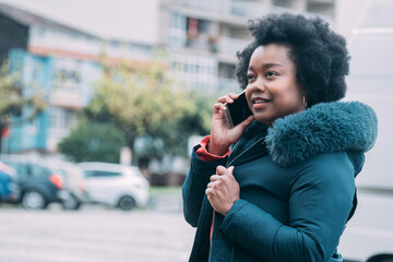 young woman with phone on the street