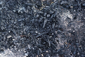 Black coal and fire ashes, close up. Cold coals.