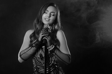 Beautiful singer with microphone, black and white effect