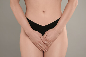 Gynecology. Woman in underwear on grey background, closeup