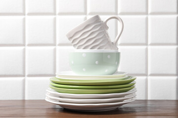 Beautiful ceramic dishware and cup on wooden table
