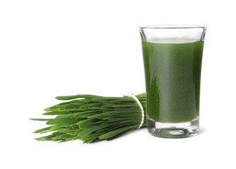 Wheat grass drink in shot glass and fresh green sprouts isolated on white