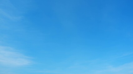 A clear blue sky with very few wispy clouds. The blue color is vibrant and consistent throughout...