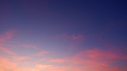 A serene sunset sky, transitioning from deep purples at the top to soft pinks and oranges near the horizon. Wisps of clouds are illuminated by the setting sun, adding texture to the tranquil scene.
