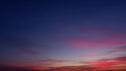 A beautiful evening sky transitioning from deep blues at the top to vibrant pinks and purples near...