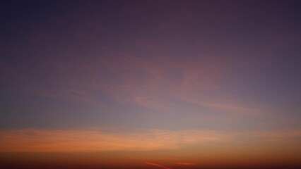 A beautiful sunrise with a gradient of colors, transitioning from deep purple at the top to warm...