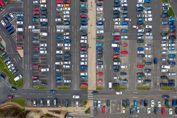Aerial drone photo of a busy car park in the town of Seacroft in Leeds West Yorkshire in the UK, showing cars parking and looking for parking spaces in the Tesco supermarket carpark