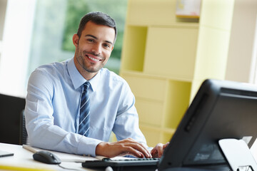 Happy, businessman and typing feedback for good news or performance review with computer in office....