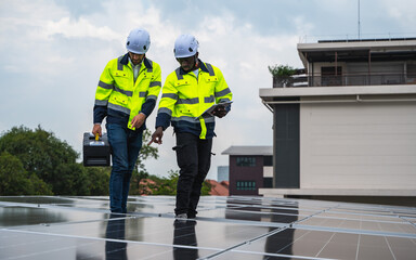Two diversity solar engineer men working together on solar roof