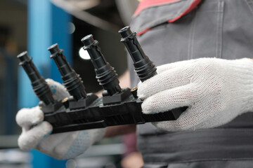 Spare parts.Car service.The cassette with ignition coils is new.Close-up. An auto mechanic monitors...