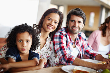 Portrait, smile and family eating lunch in home for healthy diet, nutrition and happy interracial...