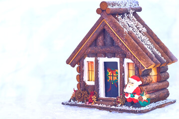Merry Christmas.Toy wooden house, Santa Claus with gifts at the doorstep