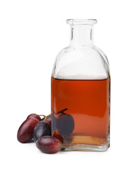 Bottle with wine vinegar and grapes isolated on white