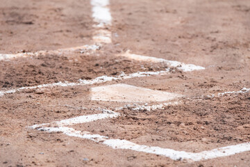Baseball base in dirt, selective focus isolated subject, background image, American game