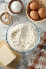 Making shortcrust pastry. Different ingredients for dough and whisk on white marble table, flat lay