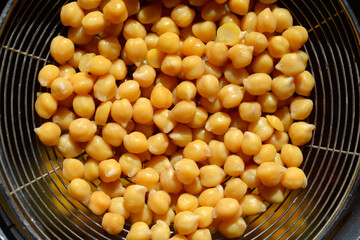 Top view of cooked chickpeas in a strainer