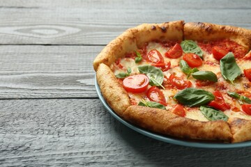 Delicious Margherita pizza on gray table, closeup. Space for text