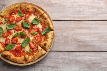 Delicious Margherita pizza on wooden table, top view. Space for text