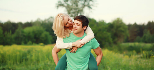 Fototapeta premium Portrait of beautiful happy smiling young couple in love together hugging in summer park